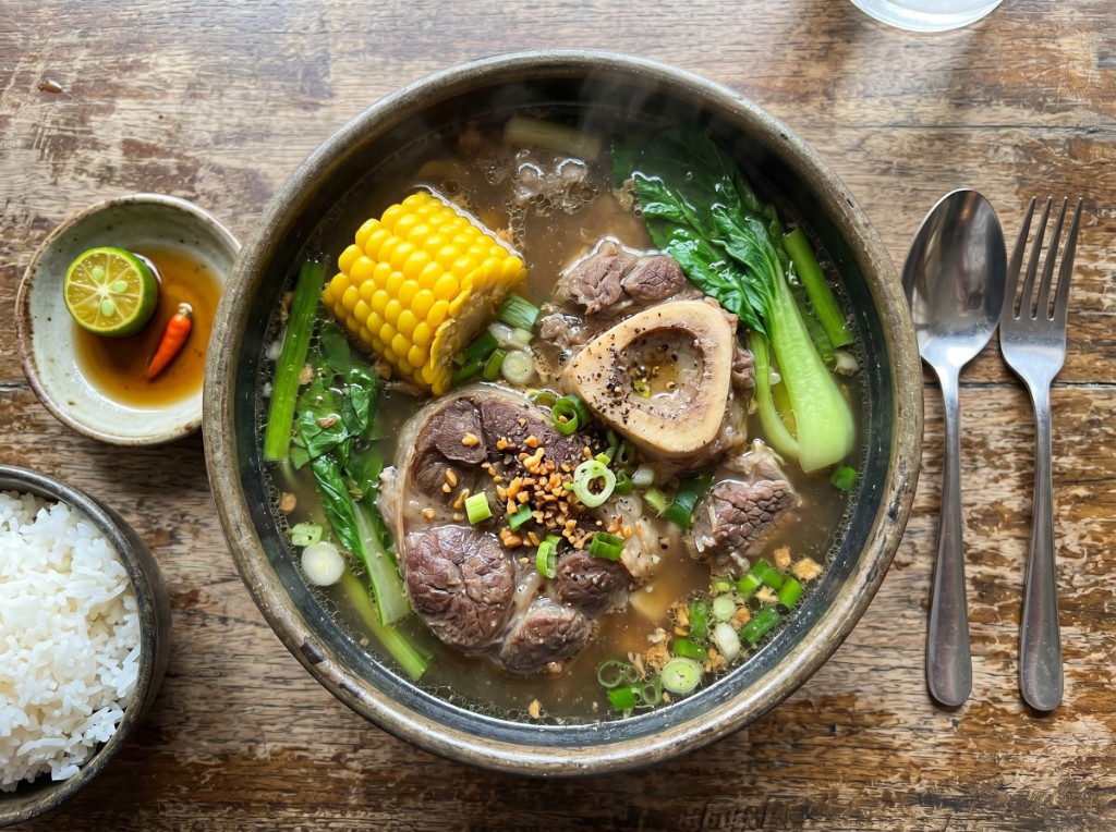 Steaming Filipino bulalo with marrow bone, corn, and pechay